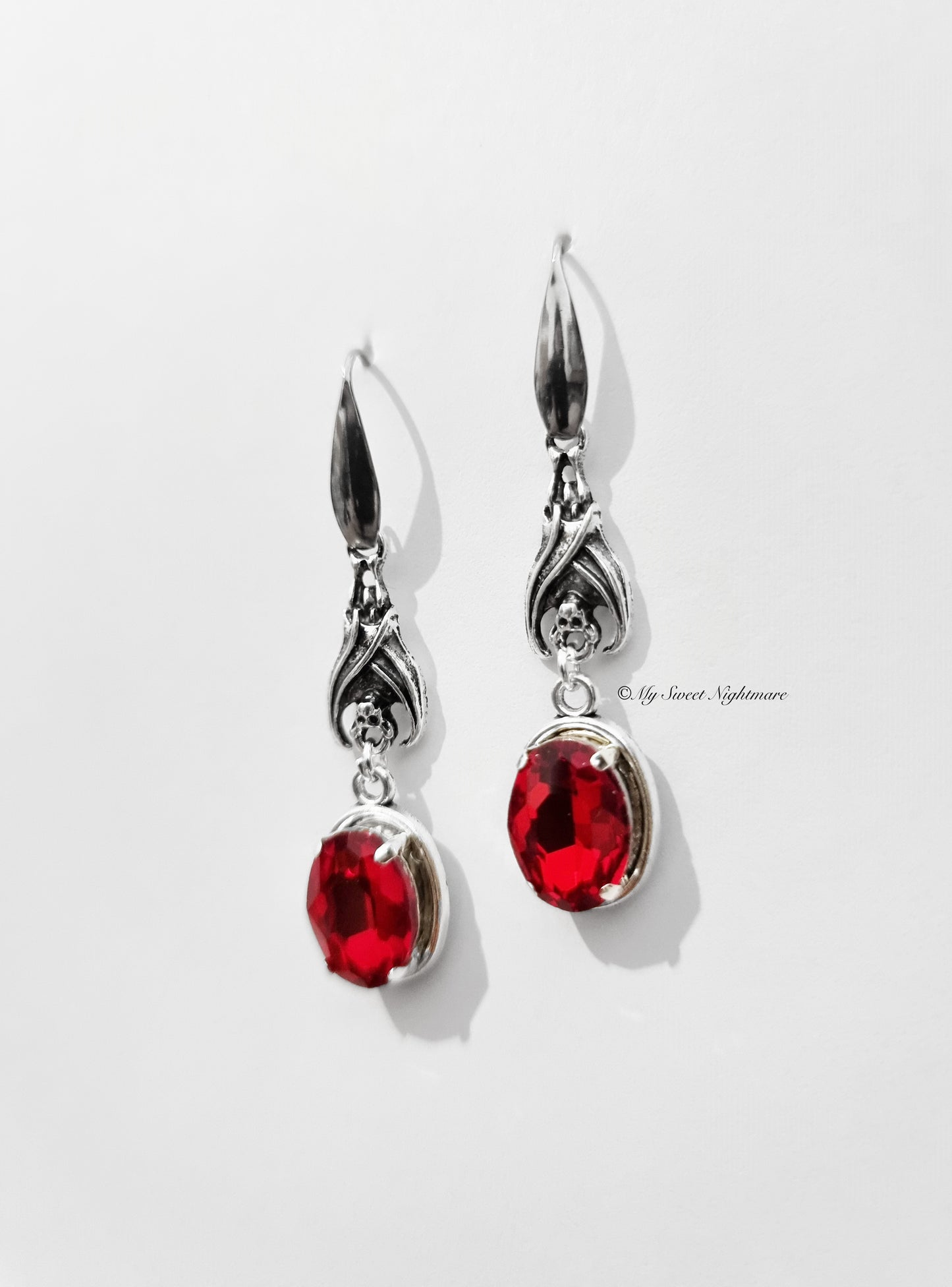 Earrings with bats and red gems