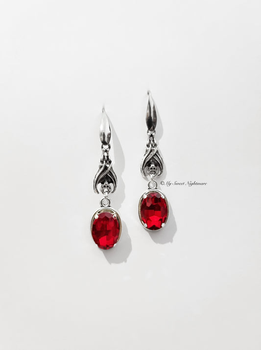 Earrings with bats and red gems