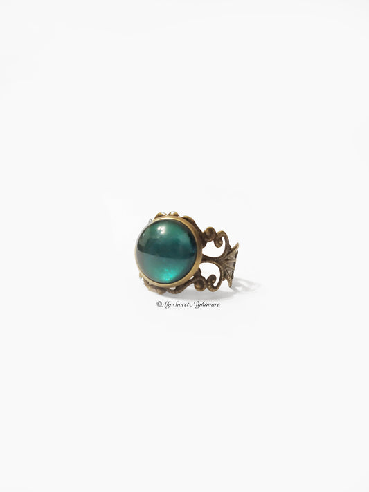 Adjustable bronze ring with green glass stone
